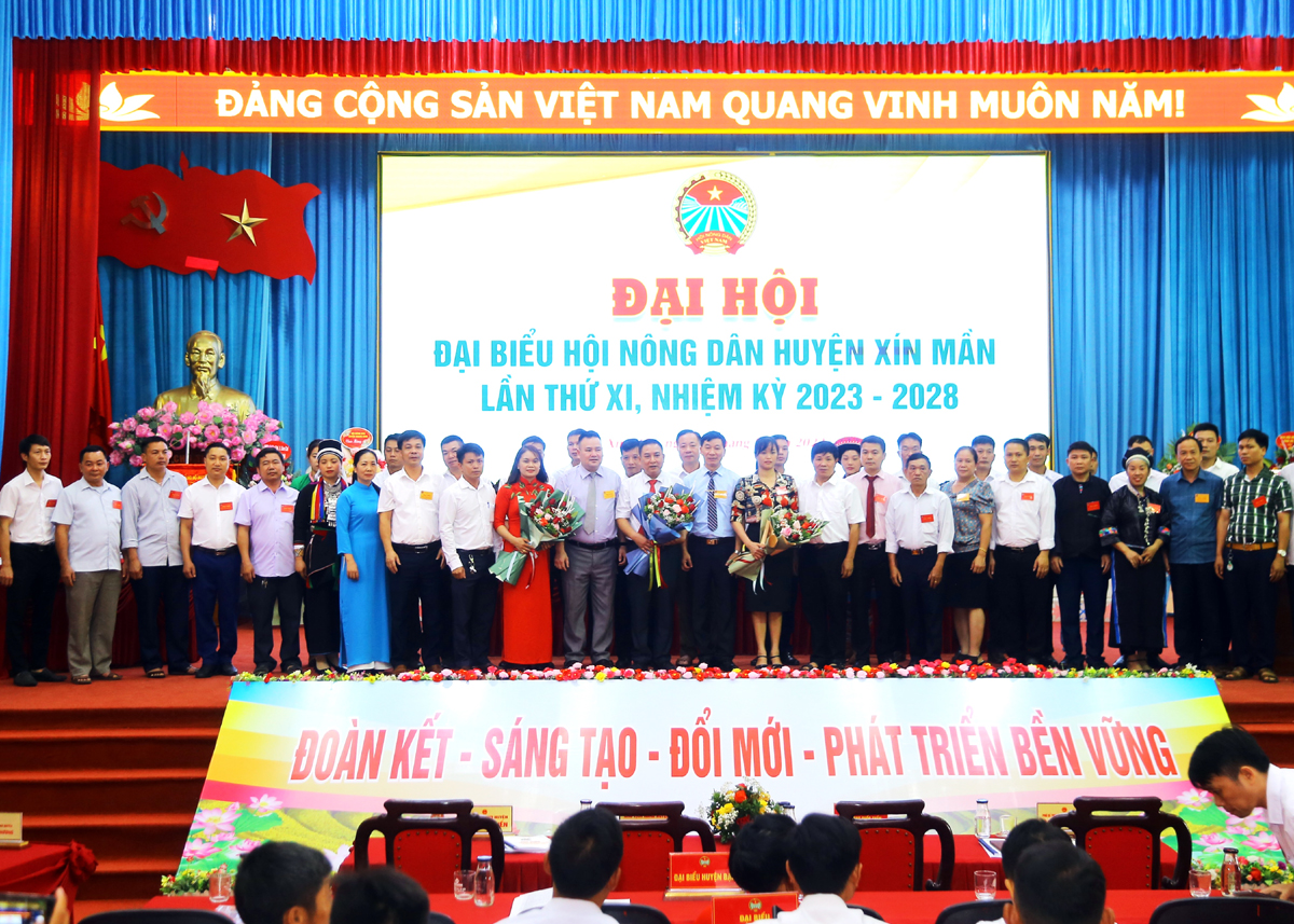 Các đại biểu tặng hoa chúc mừng BCH Hội Nông dân huyện Xín Mần khóa mới và đoàn đại biểu đi dự đại hội cấp trên.