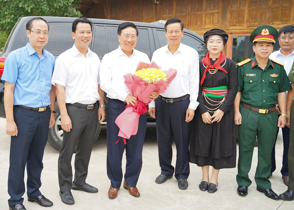 Các đồng chí lãnh đạo tỉnh tặng hoa Ủy viên Bộ Chính trị, Phó Thủ tướng Thường trực Chính phủ Phạm Bình Minh tại Nhà tiếp đón cầu Trì, huyện Bắc Quang. (1)