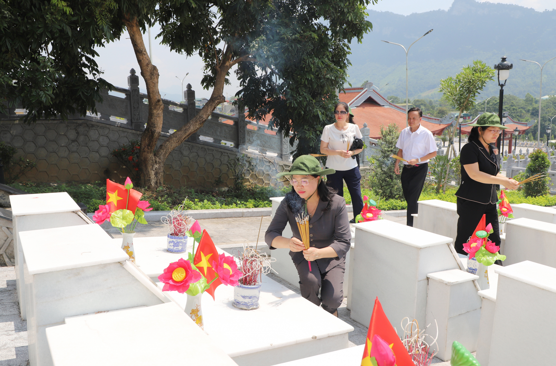 Đồng chí Phương Thị Thanh thắp hương lên từng phần mộ liệt sỹ.