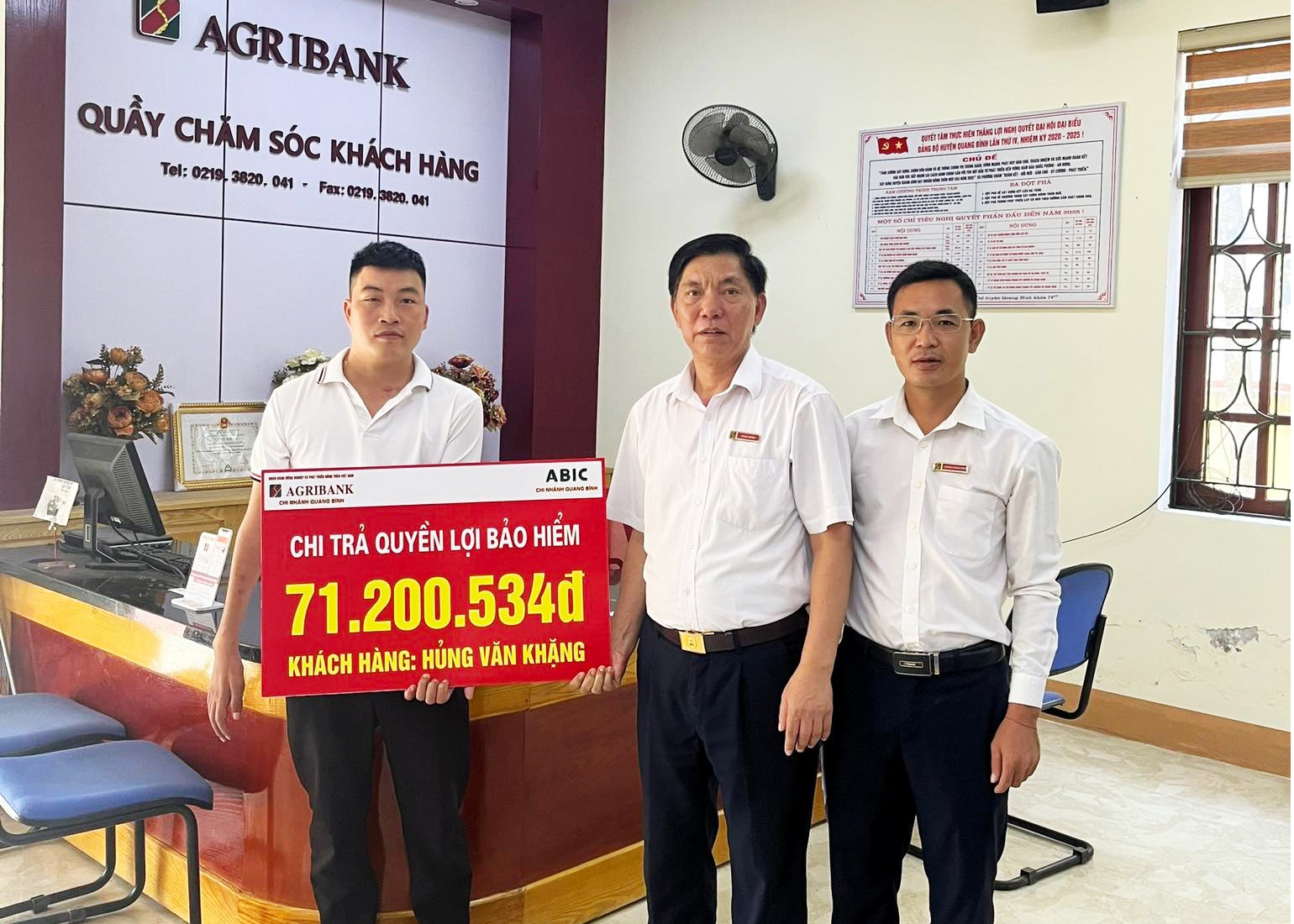 Ông Vũ Bá Bống - Giám đốc Agribank Chi nhánh Quang Bình trao biểu trưng cho đại diện gia đình ông H.V.K với số tiền chi trả 71.200.534 đồng