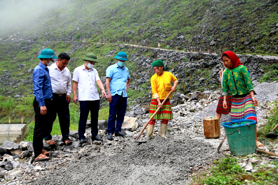 Phó Tổng biên tập Báo Hà Giang Mai Ngọc Quỳnh kiểm tra tiến độ thi công đường bê tông đi thôn Sủng Chớ.