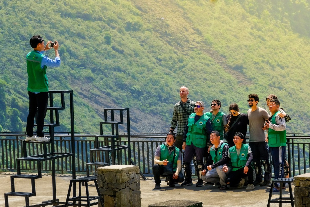 Tourists celebrate reaching the summit of Ma Pi Leng Pass