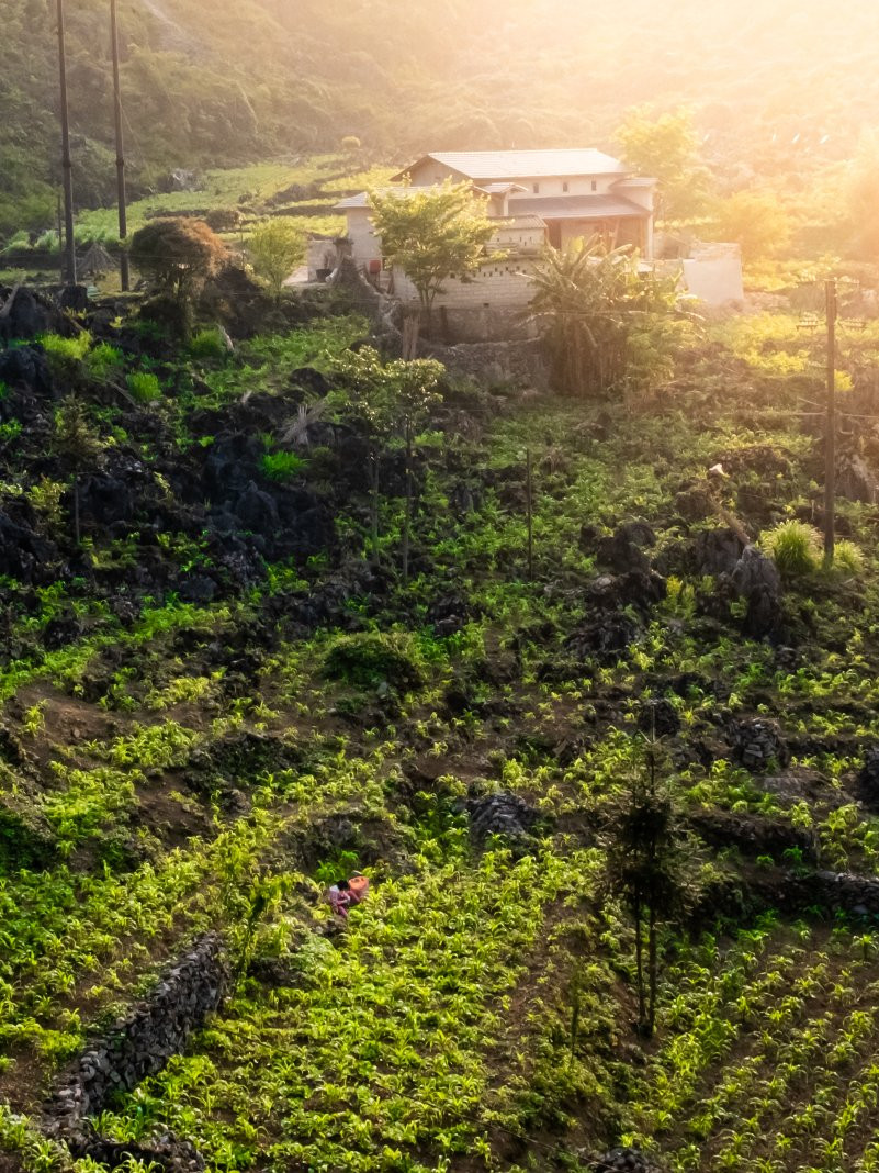 Locally built houses cling to the rugged mountain sides