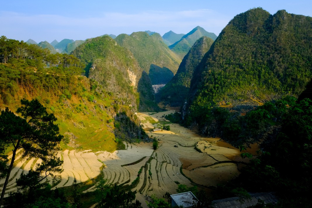 A panoramic view of a valley adorned with terraced fields