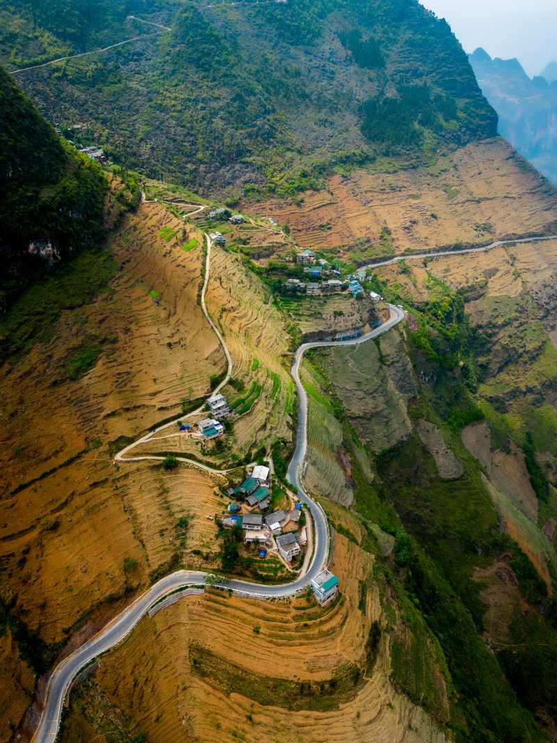 Homes perch precariously on steep slopes, showcasing unique architectural adaptation