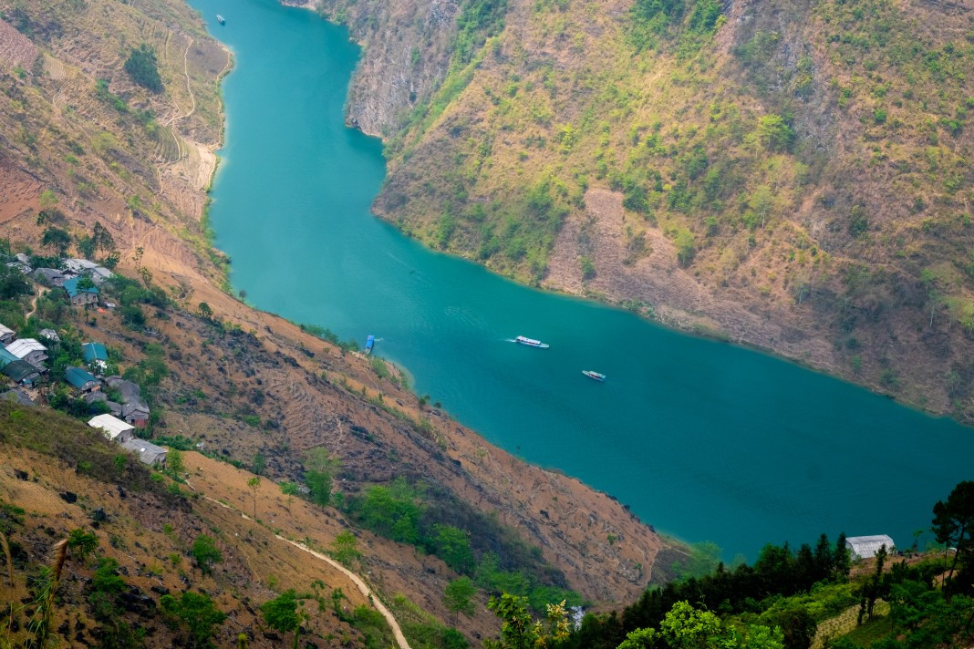 A serene boat ride on the Nho Que River offers a different perspective of the plateau