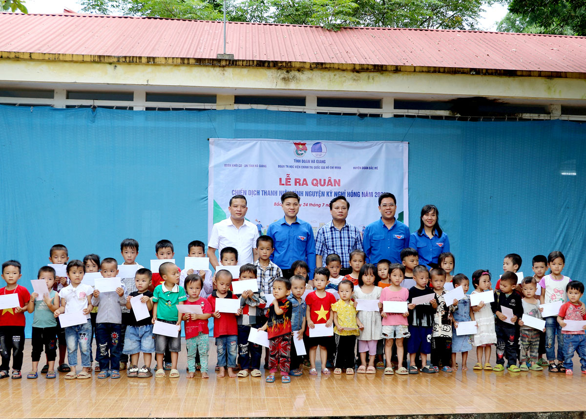 Lãnh đạo các đơn vị và đoàn viên, thanh niên tặng quà cho các  học sinh điểm trường thôn Bản Đuốc.