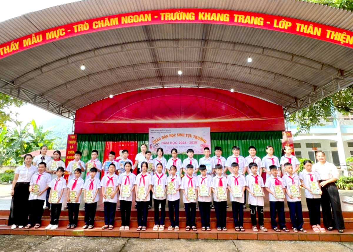 Trường THCS Quang Trung tặng vở viết cho học sinh có hoàn cảnh khó khăn.          Ảnh: LÊ HẢI