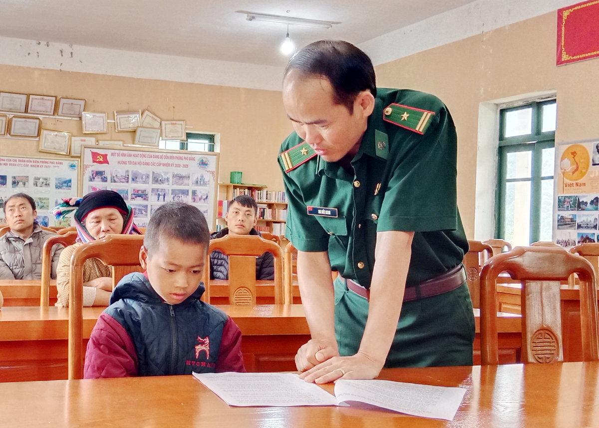 Thiếu tá Ma Đức Minh, Chính trị viên Đồn Biên phòng Phó Bảng phổ biến các chính sách hỗ trợ học sinh.