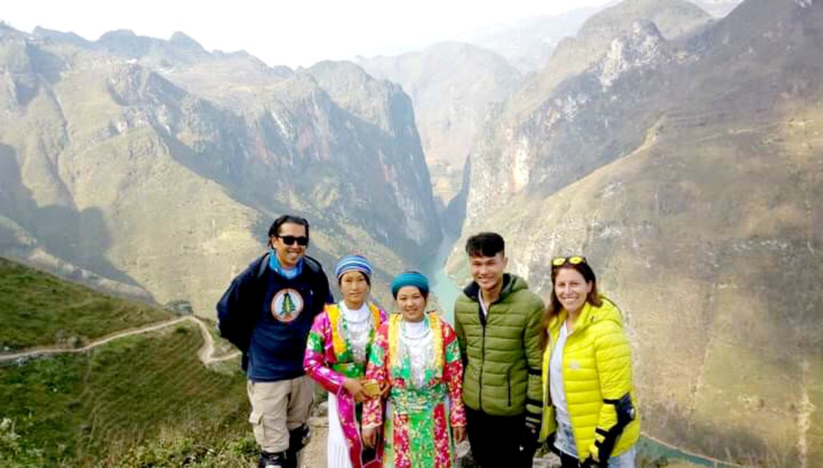 Tourists pose for a photo in front of Tu San Canyon 