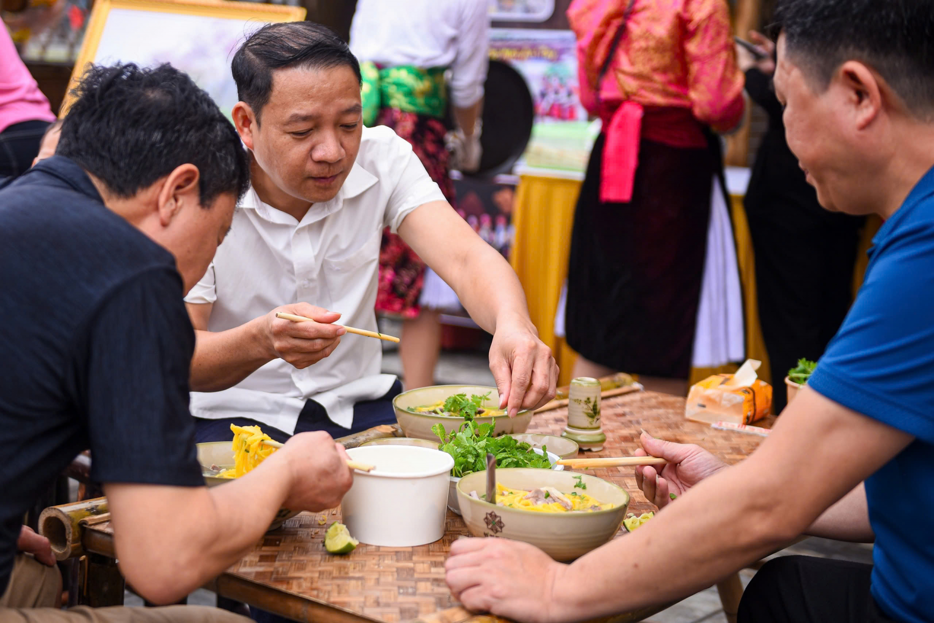 Visitors savour the dish.