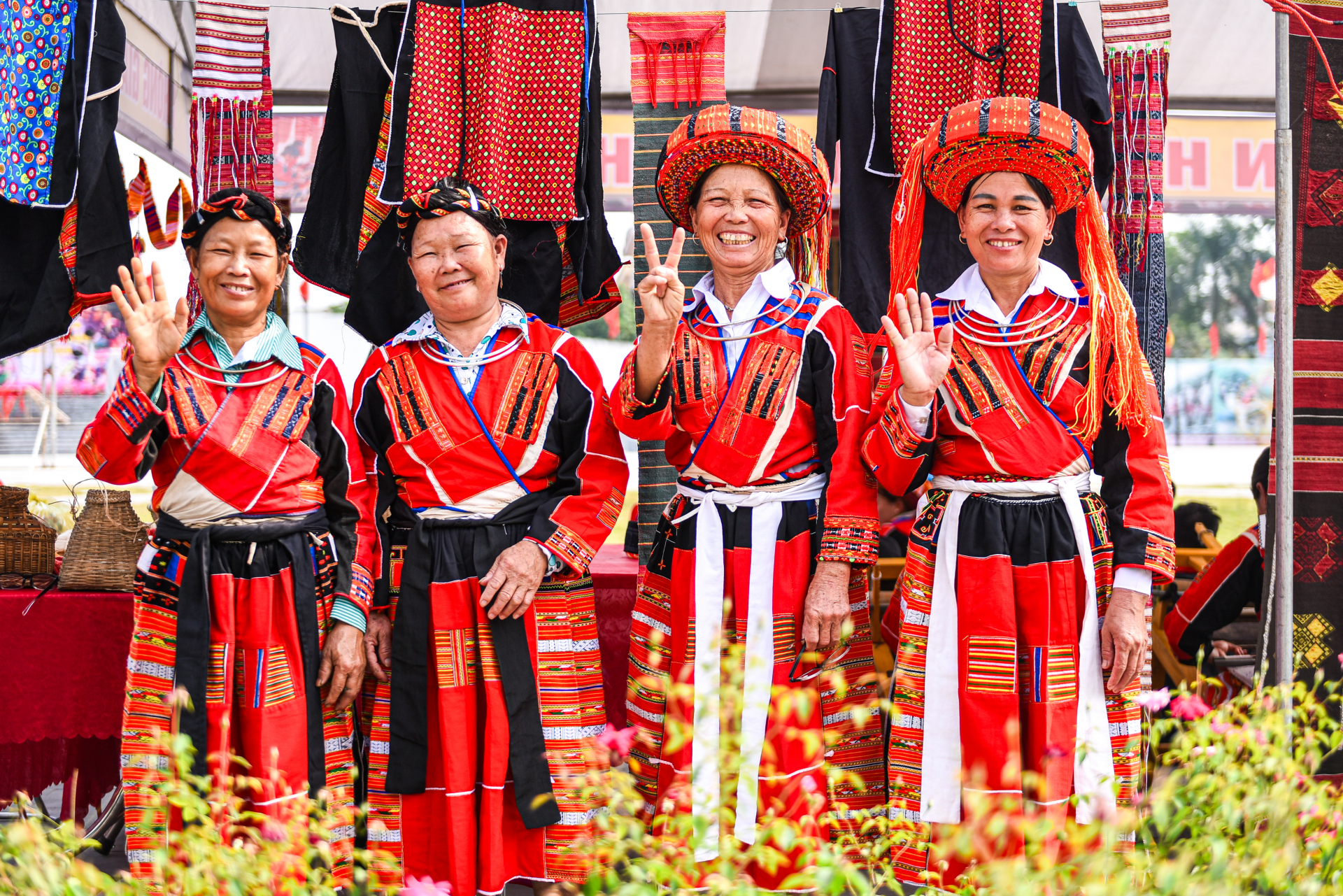 The Pa Then community, with over 5,000 members, resides mainly in six communes and towns of Quang Binh District, Ha Giang Province, such as Tan Trinh, Tan Bac, Yen Thanh, Tan Nam, Xuan Minh, and Yen Binh Town. The events central theme is the dominant red colour, a characteristic of traditional Pa Then womens attire. Even the way scarves are wrapped signifies age, marital status, or the position of a woman within the community.