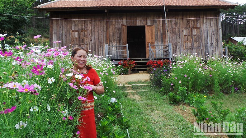 Y Lim is in front of her homestay.