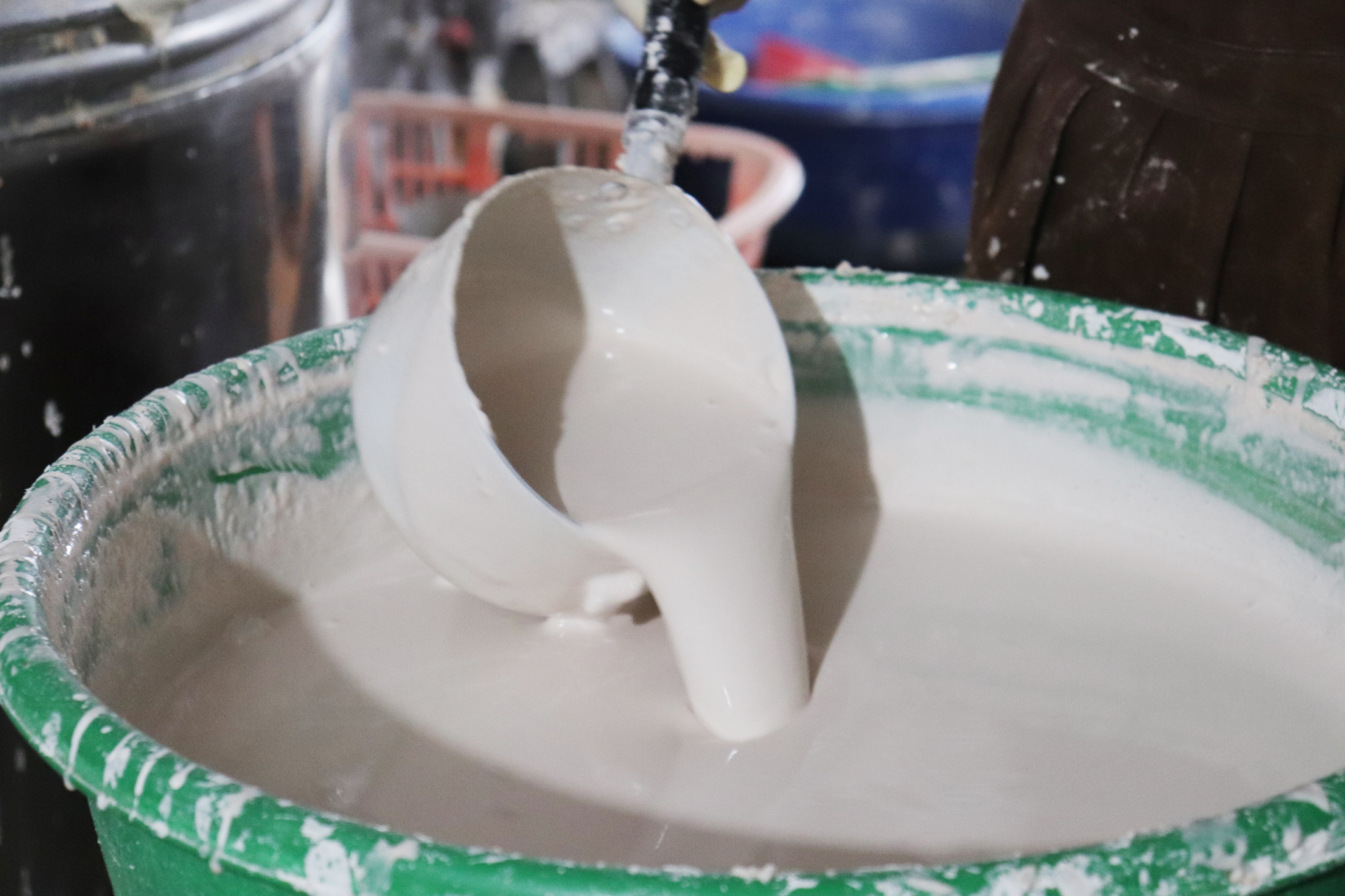 The rice is ground into a fine powder and then manually processed into rice sheets. These sheets are hung on bamboo rods to dry in the household.