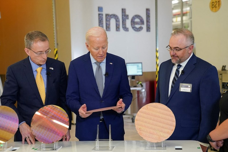 US President Joe Biden looks at a wafer, as he tours the Intel Ocotillo Campus, in Chandler, Arizona, US, on March 20, 2024. 